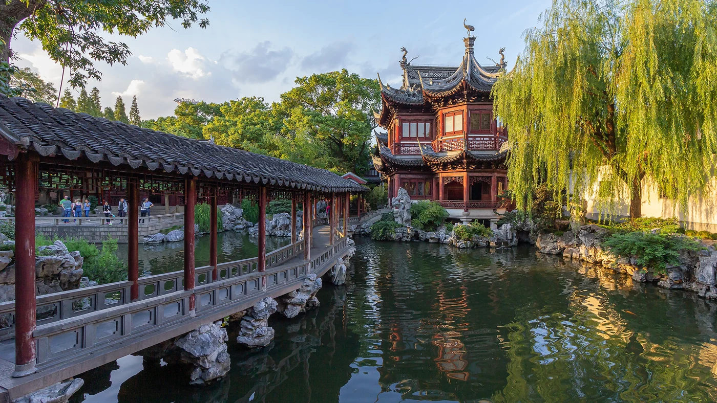 Covered walkways and a pavilion reflected in a pond at Yu Garden in Shanghai