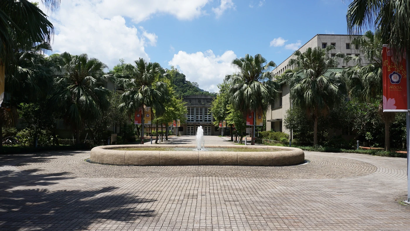 Fountain and palm trees on the lower campus of National Chengchi University