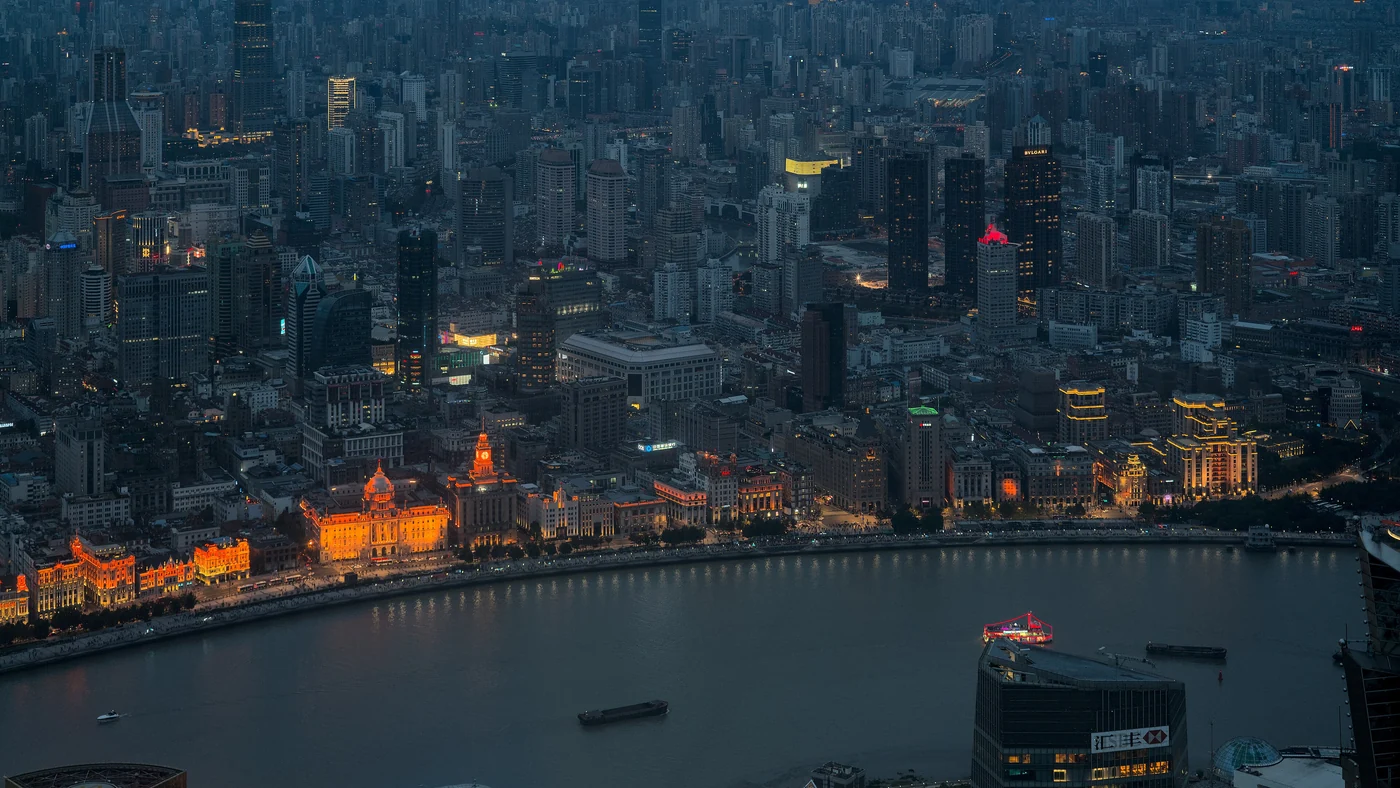 The Huangpu River and illuminated Bund seen from above at blue hour