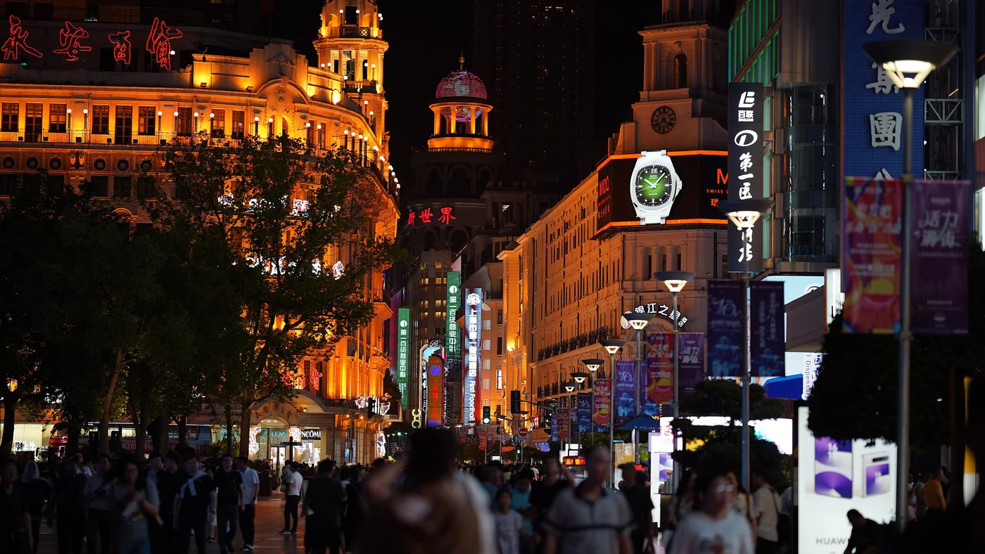 Illuminated shops and pedestrians on Nanjing Road in Shanghai